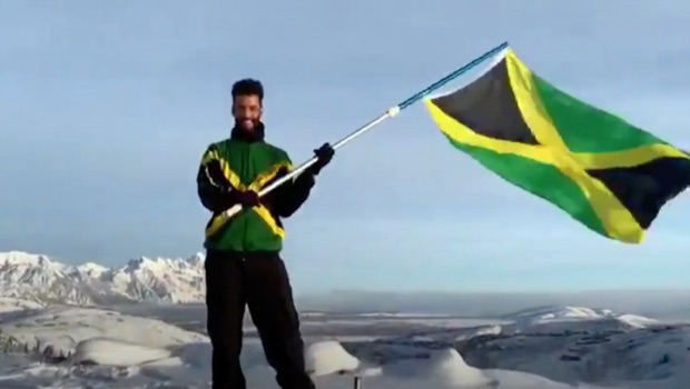 Benjamin Alexander waves a Jamaican flag